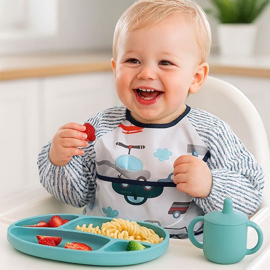 Gaçon qui mange avec la main avec bavoir bébé voiture